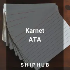 Stos kartek z napisem "Karnet ATA" na drewnianym tle.