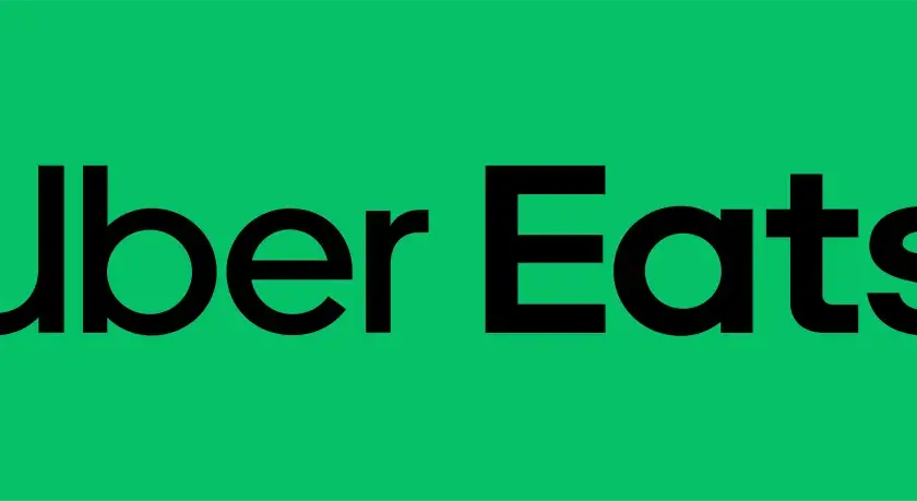 Zielony ekran z czarnym napisem "Uber Eats". Idealny na voucher Uber Eats dla miłośników jedzenia.