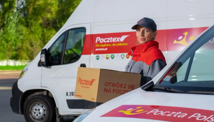 Kurierka Pocztex z paczką przed białą furgonetką. "Otwórz się na Pocztex" - zachęca napis na kartonie.