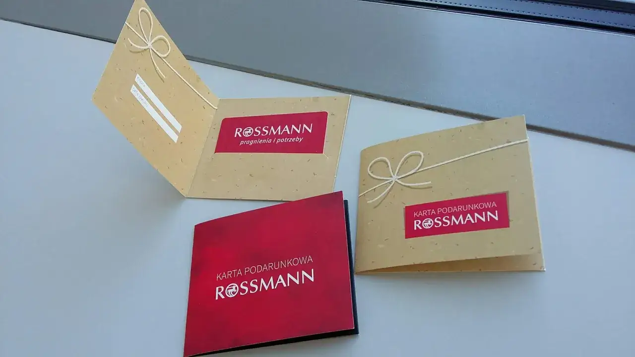 karta podarunkowa rossmann na tle promocji i produkt&oacute;w